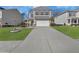 Two story house with a two car garage and landscaped yard at 9026 Jim Purcell Dr, Covington, GA 30014