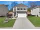 Two story house with a two car garage and landscaped yard at 9026 Jim Purcell Dr, Covington, GA 30014