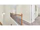 Upstairs hallway with carpet and wood railing at 9026 Jim Purcell Dr, Covington, GA 30014