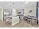 Modern kitchen with gray cabinets, granite countertops, and stainless steel appliances at 9026 Jim Purcell Dr, Covington, GA 30014