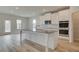 Modern kitchen with a large center island, stainless steel appliances and white cabinets at 2731 Dolce Rd, Dacula, GA 30019