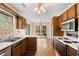 Kitchen with wood cabinets, access to sunroom and dining area at 3887 Nowlin Nw Rd, Kennesaw, GA 30144