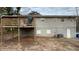 Home's back features a wooden deck and a large, mostly dirt backyard at 1272 Marlwood Ct, Stone Mountain, GA 30083