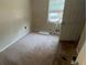 Small bedroom with brown carpet and a window at 1272 Marlwood Ct, Stone Mountain, GA 30083