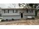 Ranch style home with gray siding, brick skirt, and a partially visible driveway at 1272 Marlwood Ct, Stone Mountain, GA 30083