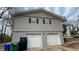 Two-car garage with white doors and gray siding at 1272 Marlwood Ct, Stone Mountain, GA 30083