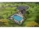 Stunning aerial view of a home with a private pool, landscaped yard, and charming outdoor lounge area at 4150 Cavalier Way, Duluth, GA 30097