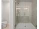 Tiled walk-in shower featuring a frameless glass door and modern fixtures in a well-lit bathroom at 4150 Cavalier Way, Duluth, GA 30097