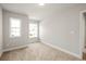 Bedroom featuring carpeted floors, neutral walls, and abundant natural light from the double-hung windows at 4150 Cavalier Way, Duluth, GA 30097