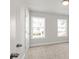 Bedroom featuring carpeted floors, neutral walls, and abundant natural light from the double-hung windows at 4150 Cavalier Way, Duluth, GA 30097