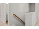 Hallway featuring a wooden handrail and trim on the landing at 4150 Cavalier Way, Duluth, GA 30097