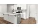 Modern kitchen with island, granite countertops, white cabinets, and stainless-steel appliances offers open living space at 4150 Cavalier Way, Duluth, GA 30097