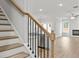 Bright, open concept living area with wood floors, a fireplace, and modern staircase at 4150 Cavalier Way, Duluth, GA 30097