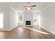 Large living room with wood floors and fireplace, with natural light from the windows at 4150 Cavalier Way, Duluth, GA 30097