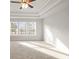 A main bedroom featuring a tray ceiling and large windows at 4150 Cavalier Way, Duluth, GA 30097