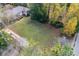 An aerial view of a home with a well-kept front yard and lush greenery, surrounded by mature trees at 1141 Goodwin Ne Pl, Brookhaven, GA 30319