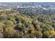 An aerial view of a home nestled among trees, showcasing the surrounding neighborhood and city skyline at 1141 Goodwin Ne Pl, Brookhaven, GA 30319
