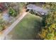 Aerial view of the home showcasing its well-maintained lawn, driveway, and surrounding trees at 1141 Goodwin Ne Pl, Brookhaven, GA 30319