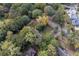 Aerial view of a property with mature trees near a paved street, showcasing its natural surroundings at 1141 Goodwin Ne Pl, Brookhaven, GA 30319
