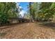 Spacious backyard featuring mature trees and a patio area perfect for outdoor entertaining at 1141 Goodwin Ne Pl, Brookhaven, GA 30319