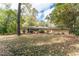 Spacious backyard featuring mature trees and a patio area perfect for outdoor entertaining at 1141 Goodwin Ne Pl, Brookhaven, GA 30319