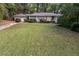 Exterior view showcasing the home's inviting facade, well-kept lawn, and attached garage at 1141 Goodwin Ne Pl, Brookhaven, GA 30319