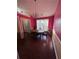 Charming dining room with hardwood floors and pink walls at 1703 Mission Park Dr, Loganville, GA 30052