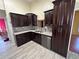 Kitchen with granite countertops and dark cabinets at 1703 Mission Park Dr, Loganville, GA 30052