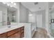 Well-lit bathroom featuring dual sinks, a soaking tub, and a glass-enclosed shower at 1965 Nocturne Dr # 1209, Alpharetta, GA 30009