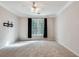 Bedroom with plush carpet, ceiling fan, and large window for plenty of natural light at 1965 Nocturne Dr # 1209, Alpharetta, GA 30009