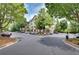 A well-maintained building with lush landscaping, mature trees, and ample parking at 1965 Nocturne Dr # 1209, Alpharetta, GA 30009