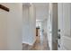 Inviting hallway with wood floors and a view into the open-concept living area at 1965 Nocturne Dr # 1209, Alpharetta, GA 30009