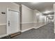 Exterior shot of front door of unit 1209, at the end of a long hallway in the building at 1965 Nocturne Dr # 1209, Alpharetta, GA 30009