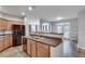 Modern kitchen with stainless steel appliances, dark countertops, and wood cabinets, and a view into the living room at 1965 Nocturne Dr # 1209, Alpharetta, GA 30009