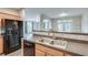 Modern kitchen area with stainless steel appliances, and wood cabinets at 1965 Nocturne Dr # 1209, Alpharetta, GA 30009