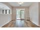 Bright living room featuring wood floors and balcony access through double glass doors at 1965 Nocturne Dr # 1209, Alpharetta, GA 30009