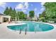 Large community swimming pool with lounge chairs, umbrellas, and mature shade trees at 1965 Nocturne Dr # 1209, Alpharetta, GA 30009