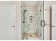 Walk-in shower with glass door and marble-style tile at 1965 Nocturne Dr # 1209, Alpharetta, GA 30009