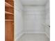 Spacious walk-in closet with custom shelving and ample storage space with carpeting at 1965 Nocturne Dr # 1209, Alpharetta, GA 30009