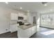 Modern kitchen with white cabinets and granite island at 445 Collins Industrial Way, Lawrenceville, GA 30046