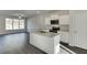 Modern kitchen with white cabinets and granite island at 445 Collins Industrial Way, Lawrenceville, GA 30046