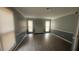 Living room with gray walls, wood floors and a fireplace at 6660 Buckingham Ct, Norcross, GA 30093