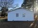 The exterior of the home features a painted white brick facade and a well-maintained yard with mature trees and greenery at 101 Mountain Brook Dr, Cumming, GA 30040