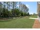 Backyard boasts lush lawn, patio and rear view of house at 106 Cherry Glen Way, Euharlee, GA 30145