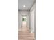Bright hallway with hardwood floors and white walls, leading to a sunlit room with large windows at 106 Cherry Glen Way, Euharlee, GA 30145