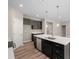 Beautiful kitchen with a large island, stainless steel dishwasher, dark cabinets, and modern lighting at 106 Cherry Glen Way, Euharlee, GA 30145