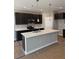 Modern kitchen featuring dark cabinetry, stainless steel appliances, a center island and pendant lighting at 106 Cherry Glen Way, Euharlee, GA 30145