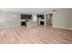 Open-concept living space with hardwood floors, a kitchen island, and modern lighting fixtures at 106 Cherry Glen Way, Euharlee, GA 30145