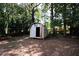 Backyard with storage shed nestled among trees at 500 Carillon Ct, Stone Mountain, GA 30083