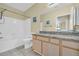 Bathroom featuring granite countertop, tiled floors, tub, and shower combo at 821 Ralph Mcgill Ne Blvd # 2303, Atlanta, GA 30306